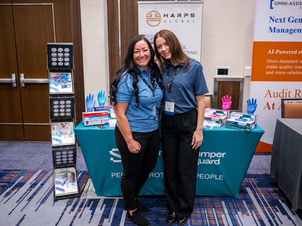 Leadership Summit exhibitors in front of their booth at the 2026 Leadership Summit