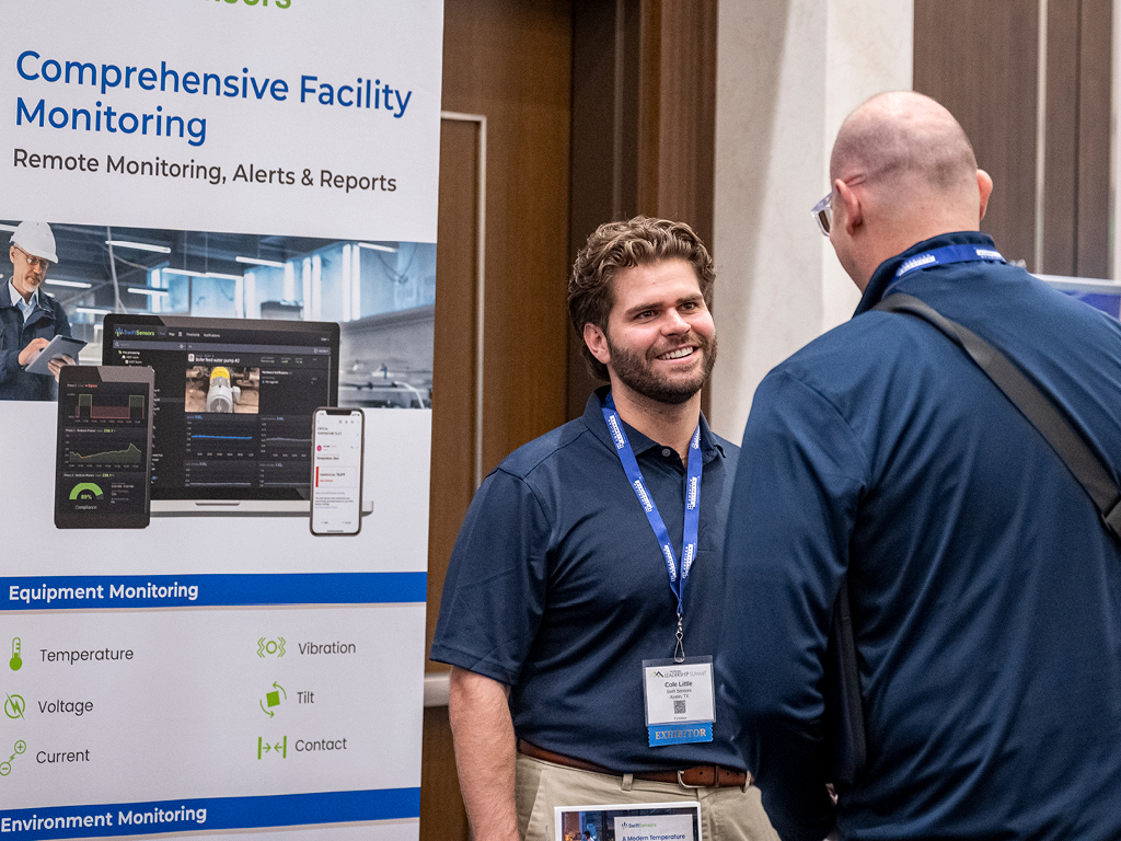 Leadership Summit exhibitors discussing solutions with attendees